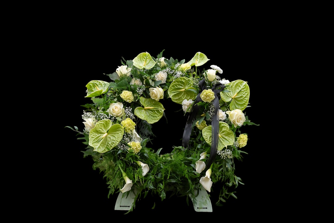 A circular floral arrangement with white and green flowers